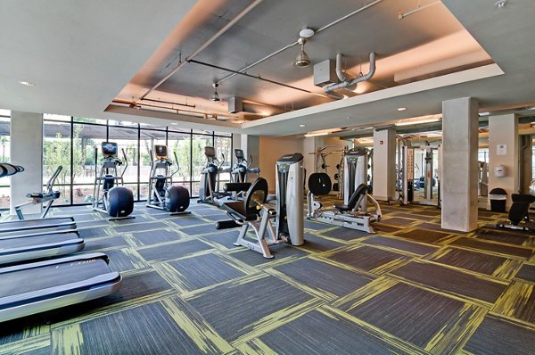 State-of-the-art fitness center at River House Apartments featuring modern equipment and spacious exercise areas