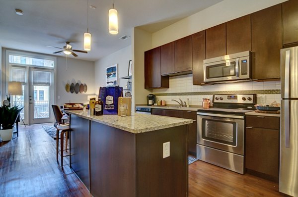 Kitchens with stainless steel appliances and granite countertops in River House Apartments