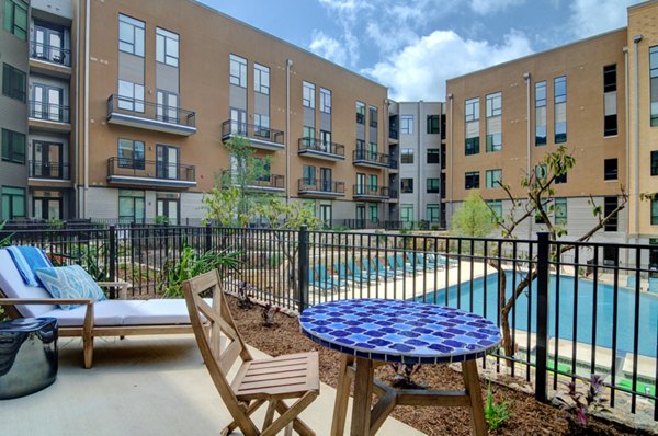 Charming patio with cozy seating at River House Apartments, perfect for relaxing and enjoying outdoor gatherings