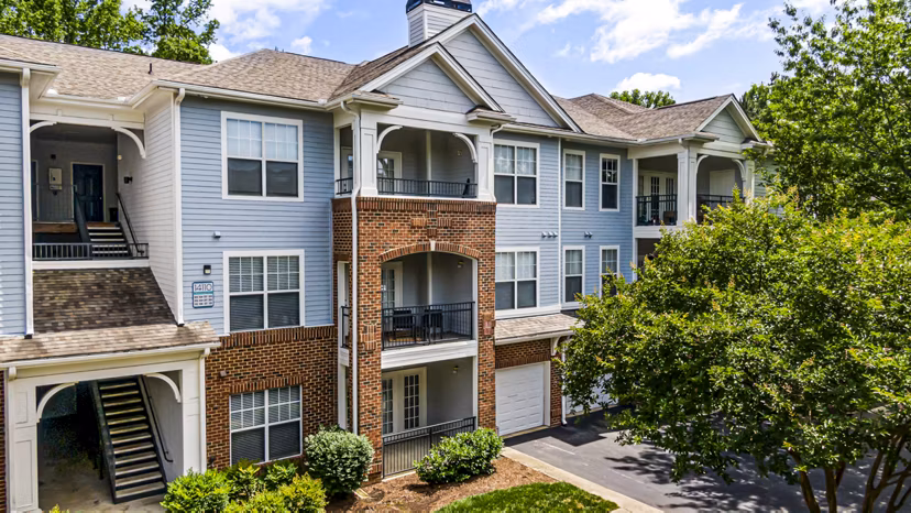 Columns at Wakefield: Elegant architecture and lush landscaping surrounding luxury apartment community