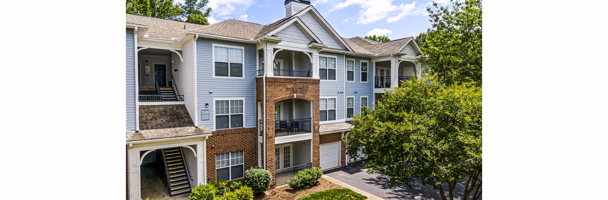 Columns at Wakefield: Elegant architecture and lush landscaping surrounding luxury apartment community