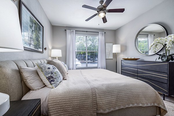 Elegant bedroom featuring a king-sized bed and modern decor in Columns at Wakefield luxury apartments