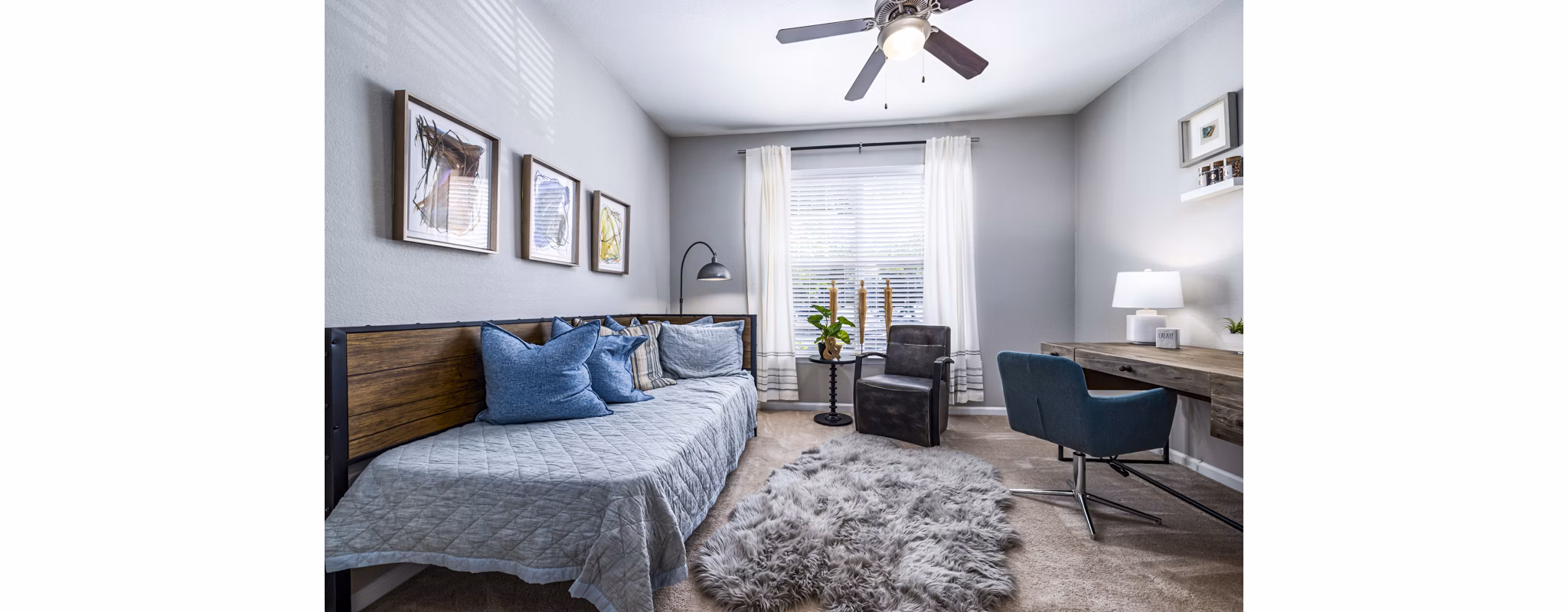Cozy bedroom with a dedicated home office space at Columns at Wakefield luxury apartments, ideal for remote work and relaxation