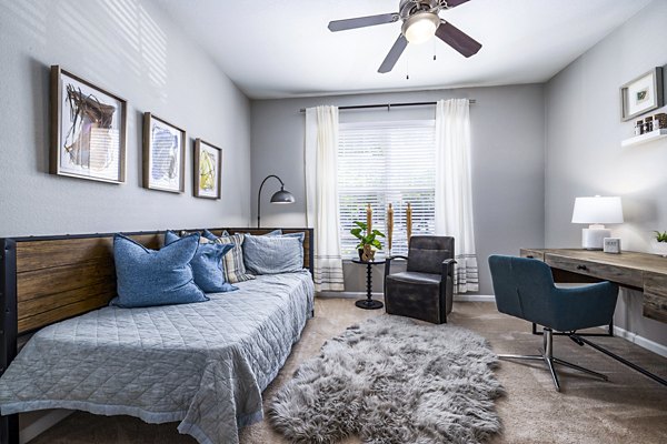 Cozy bedroom with a dedicated home office space at Columns at Wakefield luxury apartments, ideal for remote work and relaxation