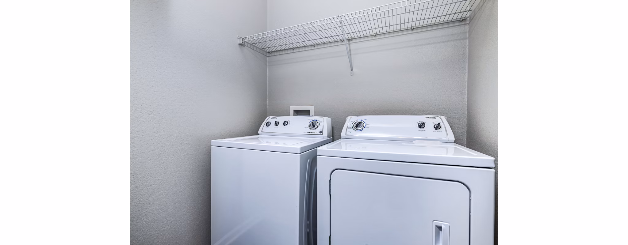 Modern laundry room with high-efficiency washers and dryers at Columns at Wakefield apartments