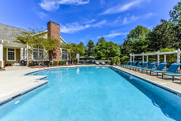 Outdoor pool with lounge chairs at Columns at Wakefield Apartments