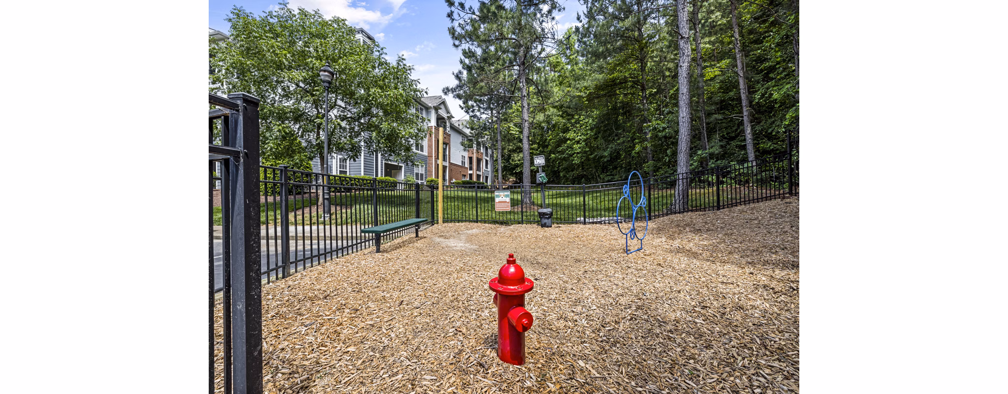 Fenced dog park with agility course at Columns at Wakefield apartments