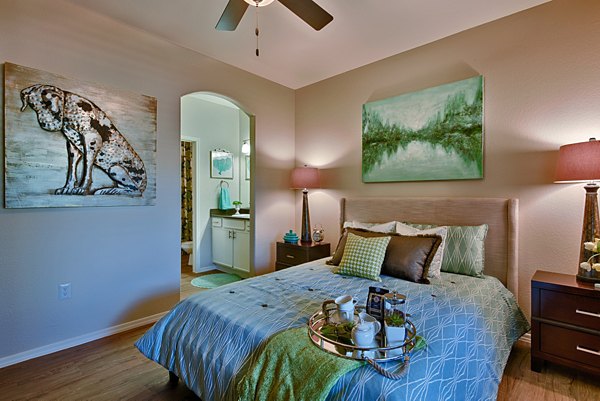 Cozy bedroom with modern decor at Pinnacle Terrace Apartments, featuring plush bedding and natural light