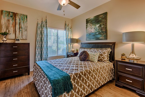 Spacious bedroom with large windows and modern decor at Pinnacle Terrace Apartments, offering luxurious living spaces in a serene environment