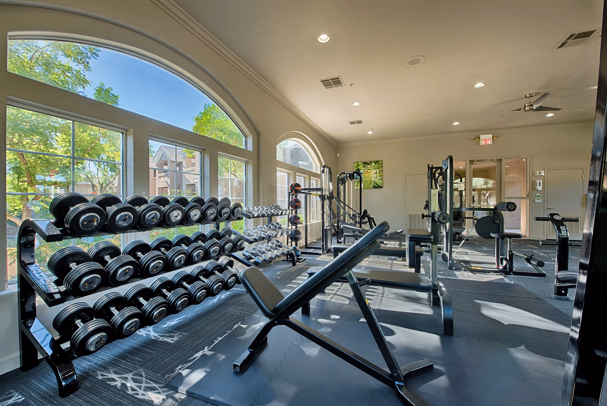 State-of-the-art fitness center equipped with modern workout machines at Pinnacle Terrace Apartments