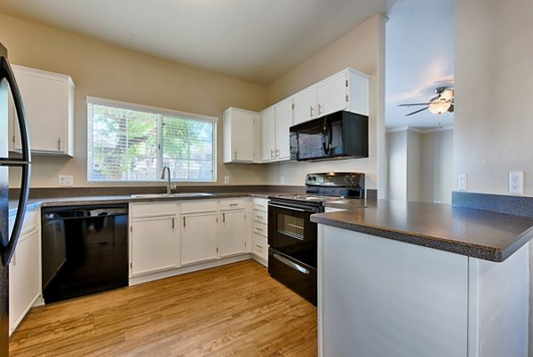 Kitchens with modern appliances and granite countertops at Pinnacle Terrace Apartments, luxury living by Greystar