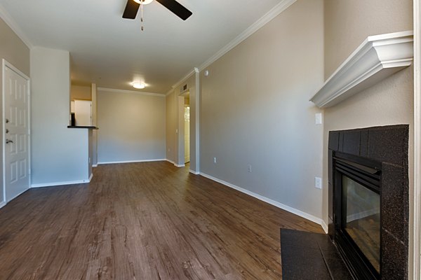 Elegant living room with modern decor and large windows in Pinnacle Terrace Apartments