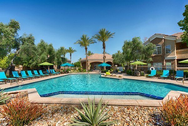 Resort-style pool with lounge chairs at Pinnacle Terrace Apartments, offering luxury leisure living in a serene environment