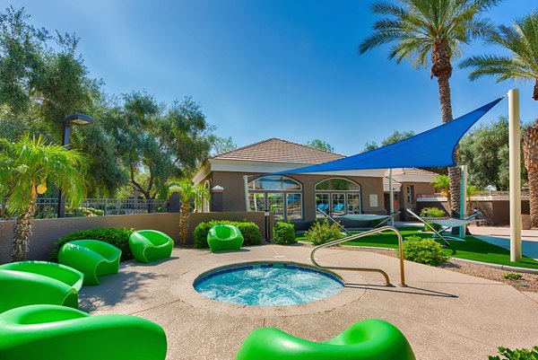 Resort-style pool with lounge chairs at Pinnacle Terrace Apartments, offering a relaxing oasis for residents