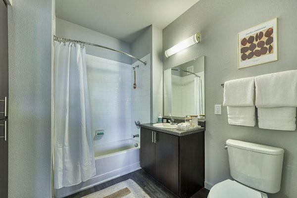 Contemporary bathroom with sleek fixtures and marble countertop at Seven Apartments
