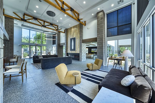 Modern clubhouse with cozy seating and pool table at Seven Apartments, luxury Greystar property ideal for social gatherings in Miami