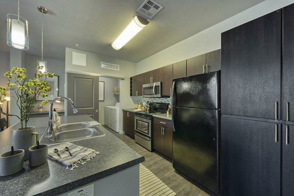 Modern kitchen with stainless steel appliances at Seven Apartments