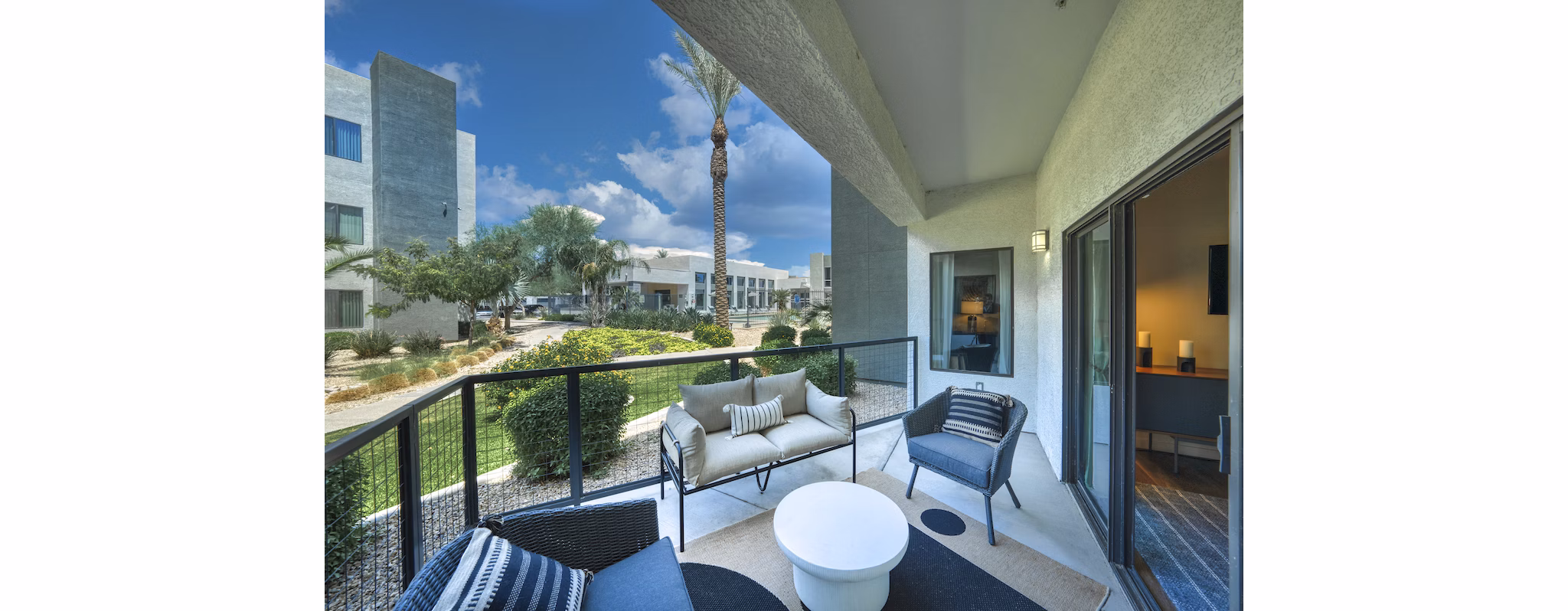 Spacious outdoor patio with modern seating at Seven Apartments, perfect for relaxation and social gatherings in a luxury setting