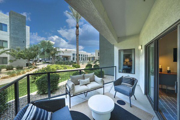 Spacious outdoor patio with modern seating at Seven Apartments, perfect for relaxation and social gatherings in a luxury setting