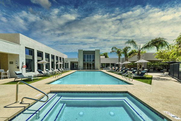 Resort-style pool with lounge chairs at Seven Apartments