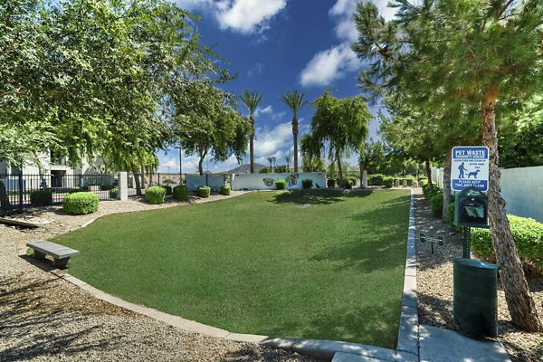 Dog park at Seven Apartments: Spacious fenced area with agility equipment and seating for resident enjoyment