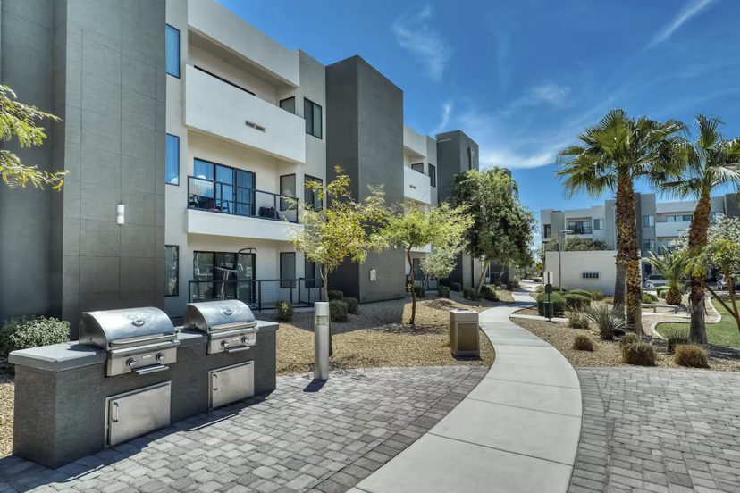 Outdoor grill area with sleek seating at Seven Apartments