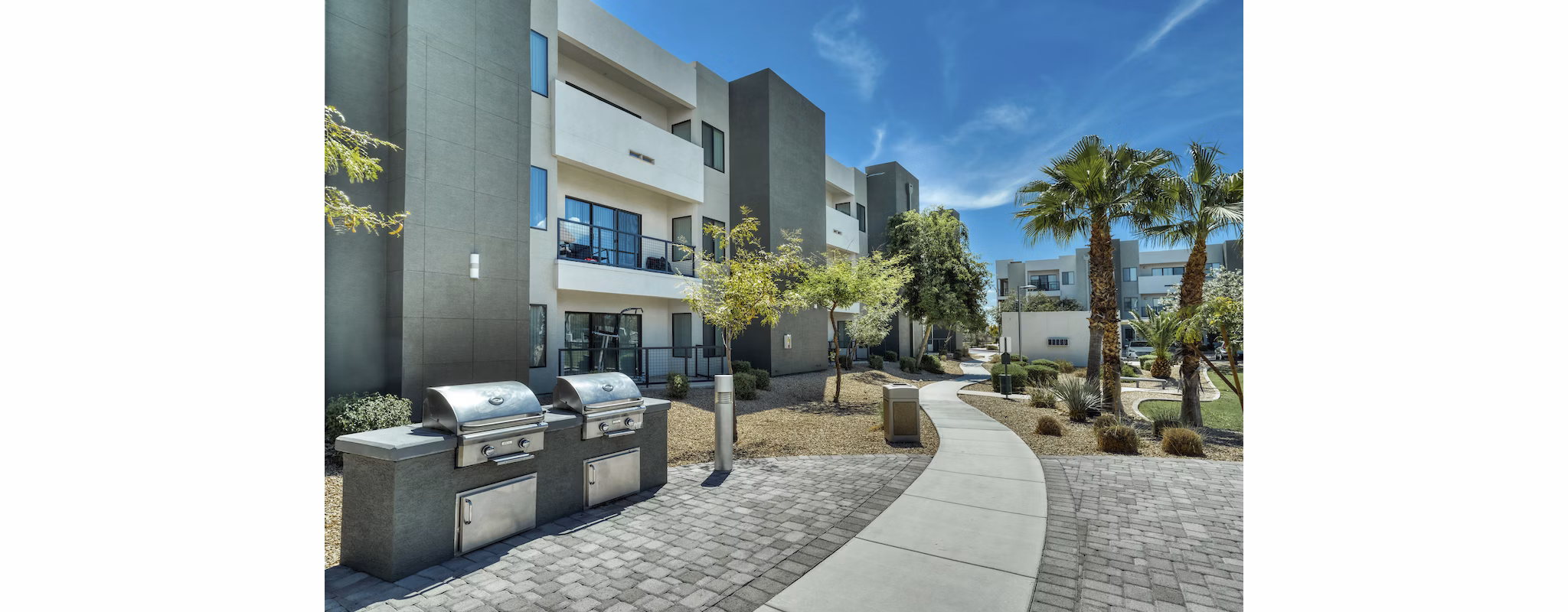 Outdoor grill area with sleek seating at Seven Apartments