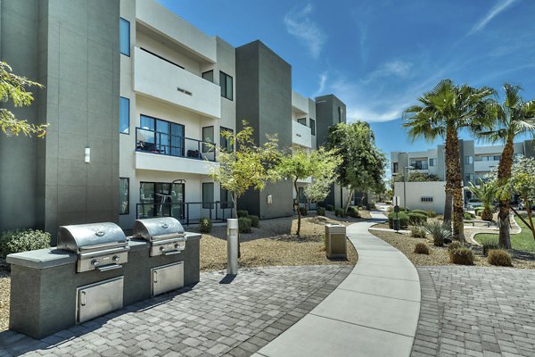 Outdoor grill area with sleek seating at Seven Apartments