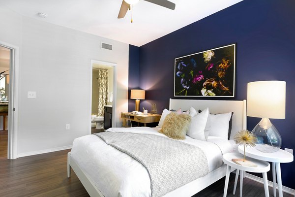 Cozy bedroom with stylish decor at Folio Apartments, a Greystar luxury community