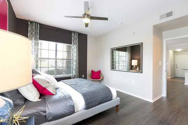 Bedroom featuring contemporary design and plush bedding at Folio Apartments, a luxury living space by Greystar