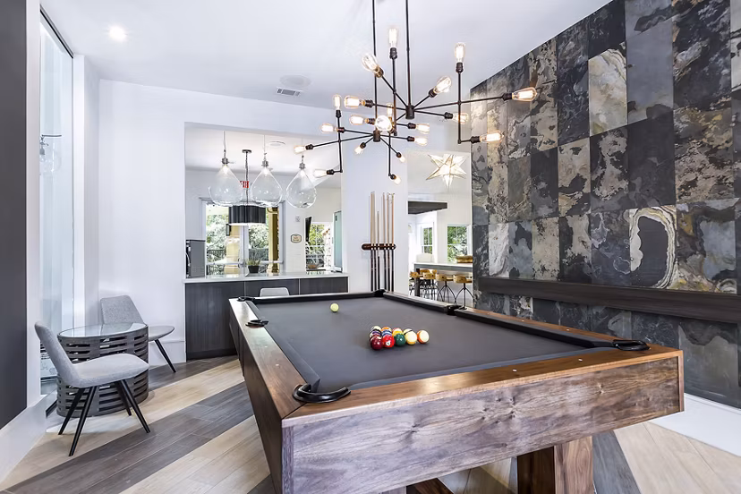 Game room featuring pool table and gaming consoles at Folio Apartments Luxury amenities for relaxation and entertainment in a community setting