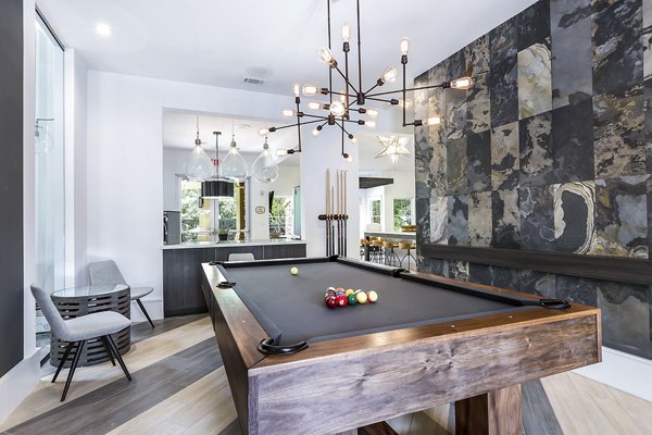 Game room featuring pool table and gaming consoles at Folio Apartments Luxury amenities for relaxation and entertainment in a community setting
