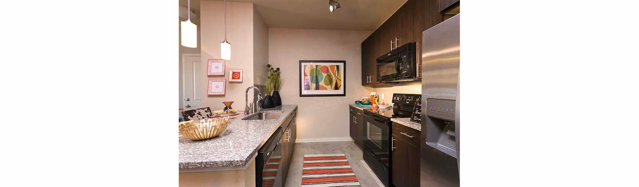Modern kitchen with stainless steel appliances at HiLine at Littleton Commons Apartments