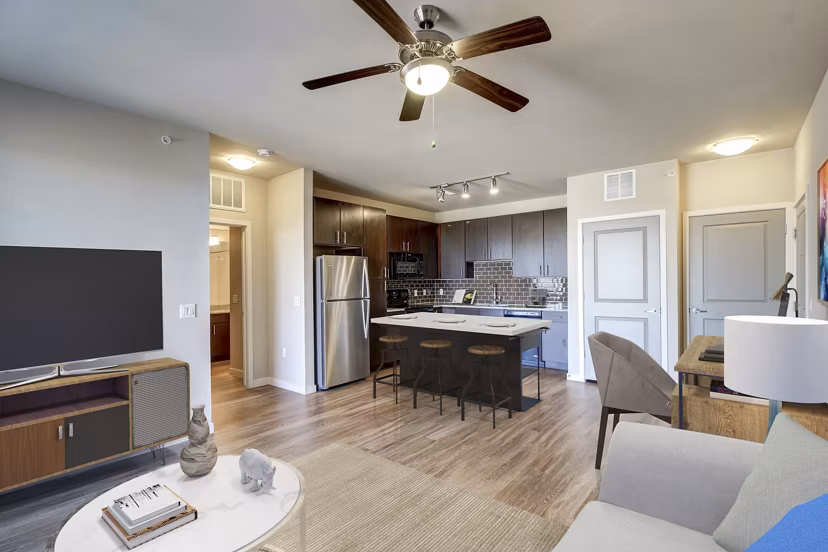 Living room with modern decor and large windows at HiLine at Littleton Commons Apartments