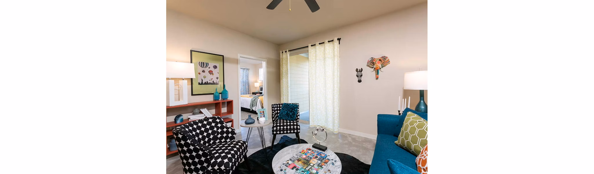 Living room with modern decor and large windows at HiLine at Littleton Commons Apartments
