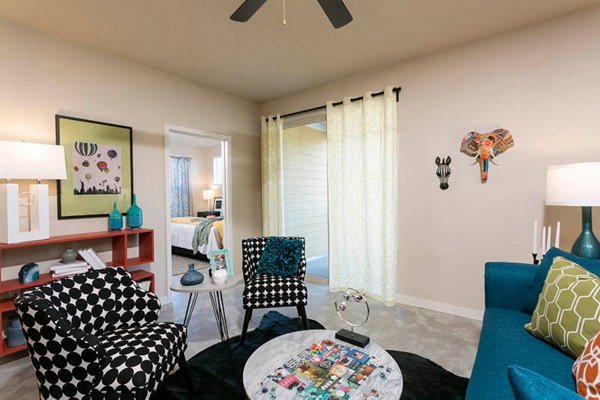 Living room with modern decor and large windows at HiLine at Littleton Commons Apartments