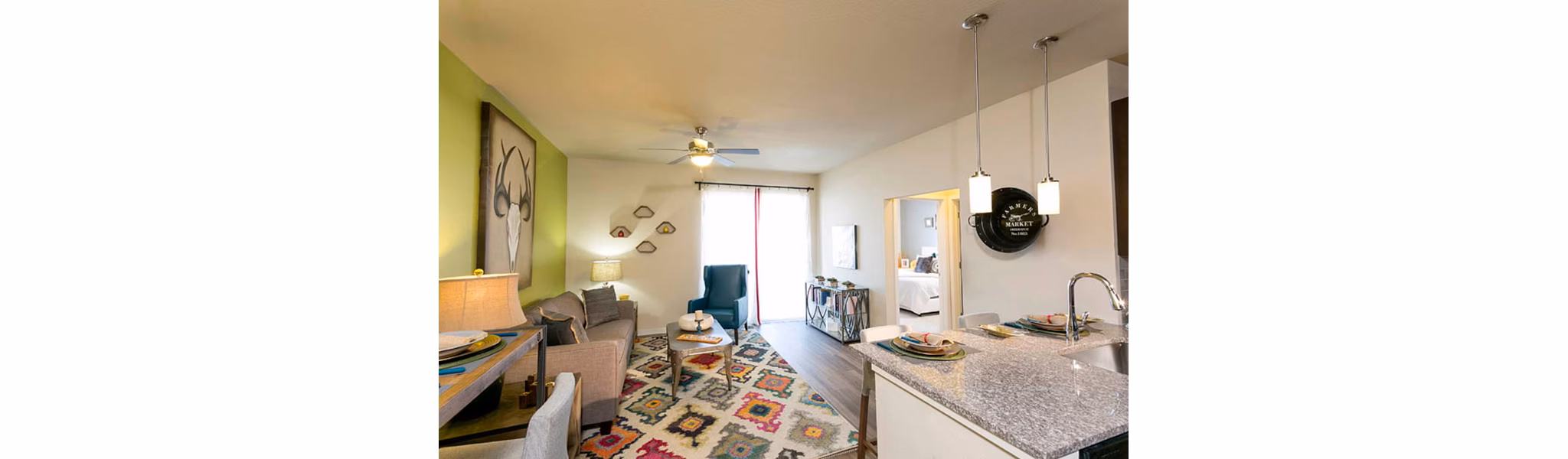 Bright living room with modern decor at HiLine at Littleton Commons Apartments, featuring cozy seating and ample natural light
