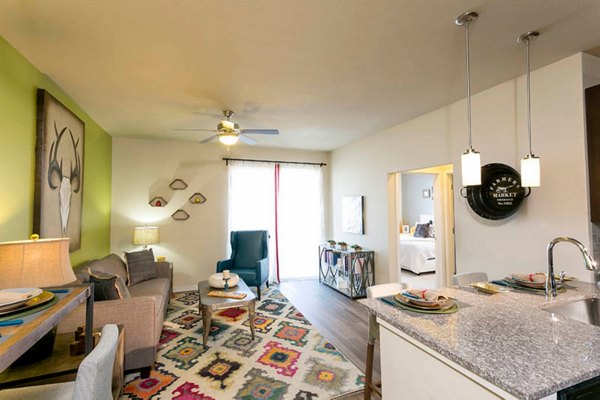 Bright living room with modern decor at HiLine at Littleton Commons Apartments, featuring cozy seating and ample natural light