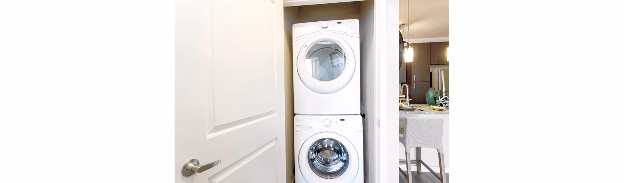 Laundry room with modern appliances at HiLine at Littleton Commons apartments