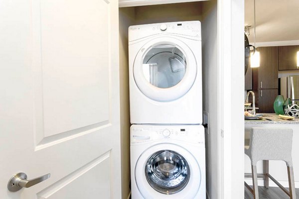 Laundry room with modern appliances at HiLine at Littleton Commons apartments