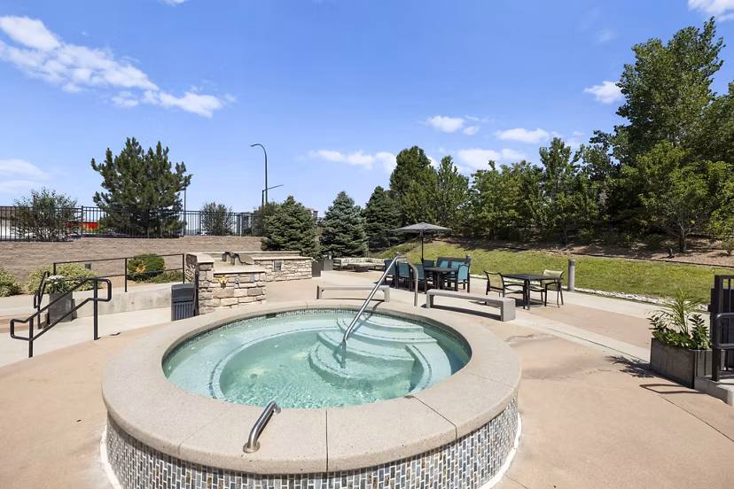 Luxury pool with lounging area at HiLine at Littleton Commons Apartments