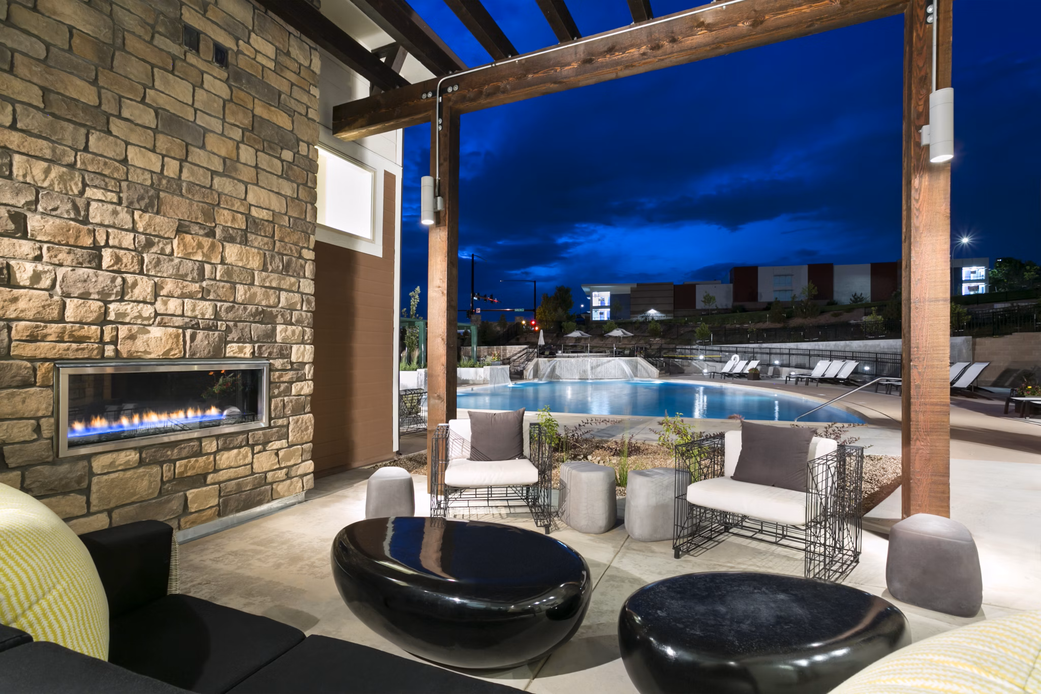 Luxury pool with lounging area at HiLine at Littleton Commons Apartments