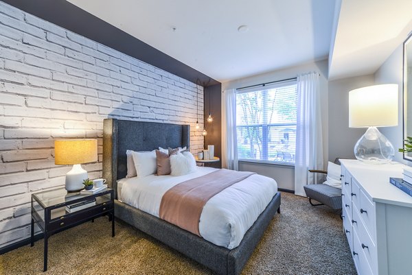 Cozy bedroom featuring modern decor and ample natural light at Avana Westside Apartments