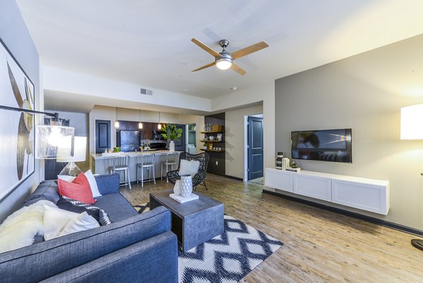 Spacious living room with modern decor and natural light in Avana Westside Apartments