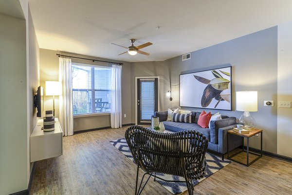 Spacious living room with modern decor and natural light at Avana Westside Apartments