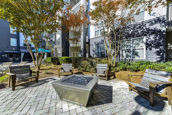 Fire pit seating area with cozy lighting at Avana Westside Apartments, a luxury community offering outdoor relaxation spaces