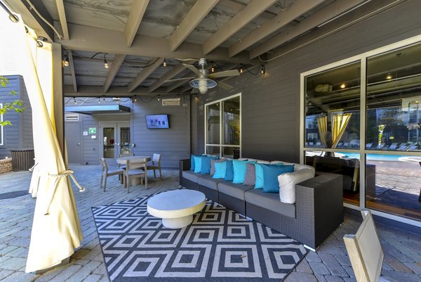 Cozy outdoor patio with modern seating at Avana Westside Apartments, ideal for relaxation and social gatherings in a vibrant community