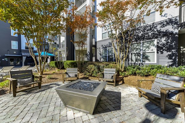 Fire pit seating area at Avana Westside Apartments, perfect for social gatherings and outdoor relaxation
