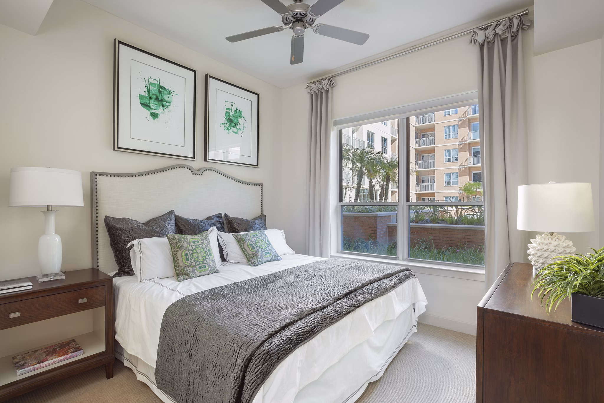 Luxurious bedroom featuring lake views and modern decor at One Lakes Edge apartments