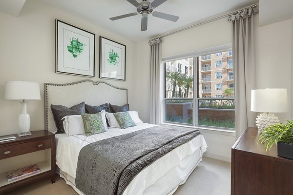 Luxurious bedroom featuring lake views and modern decor at One Lakes Edge apartments